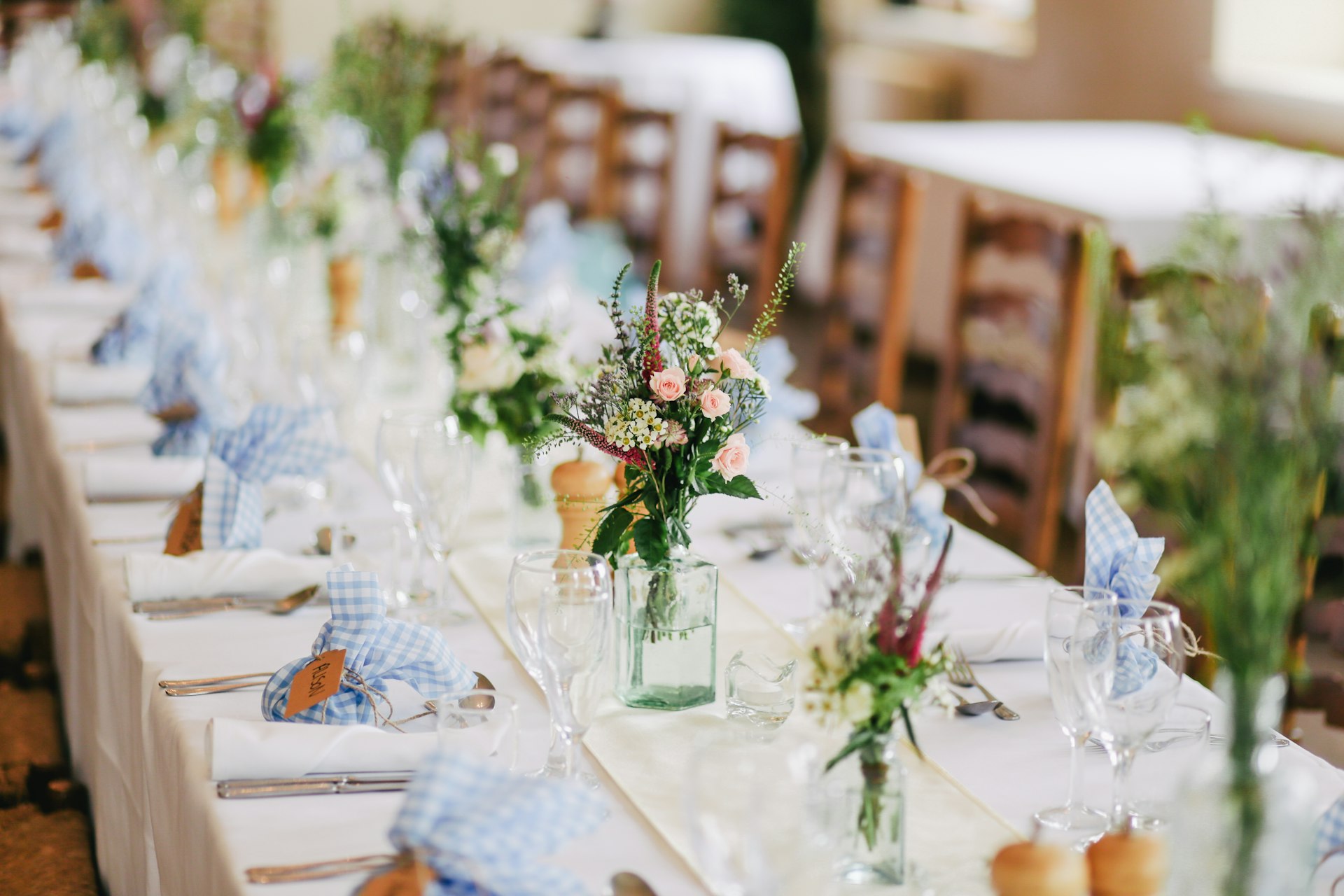 Elegant wedding tablescape with plates, glassware and florals